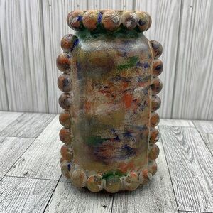 Handmade multi-colored painted round jar with texture.
